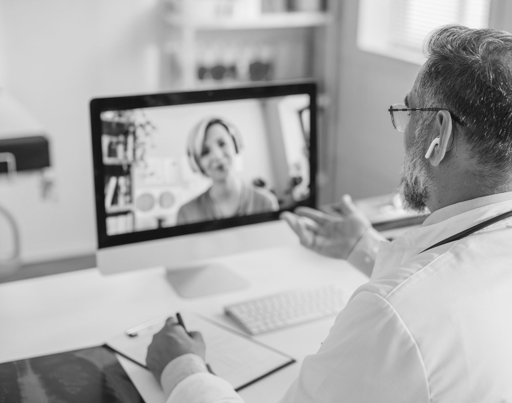 Man looking at woman on computer screen